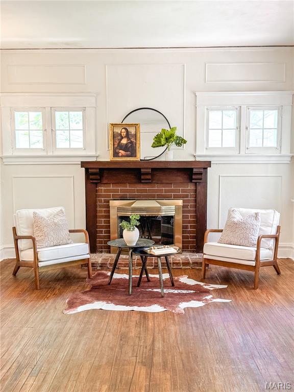 24 S Barat Ave, Saint Louis, MO 63135 - sitting room featuring a decorative wall, wood finished floors, and a fireplace