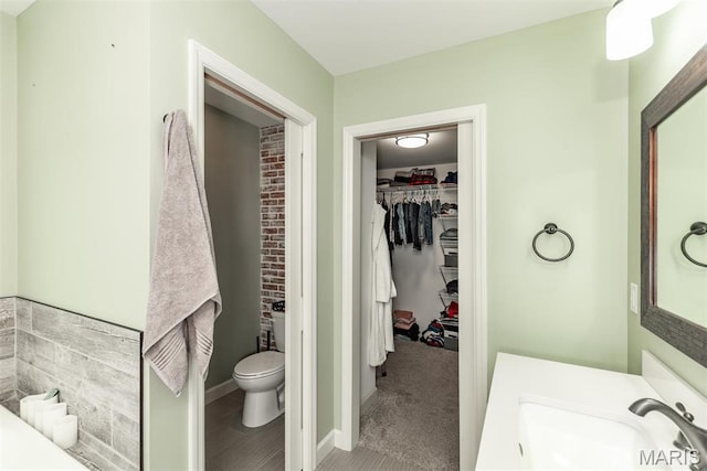 5814 Calvey Creek Rd, Robertsville, MO 63072 - full bathroom with toilet, a sink, a spacious closet, and baseboards