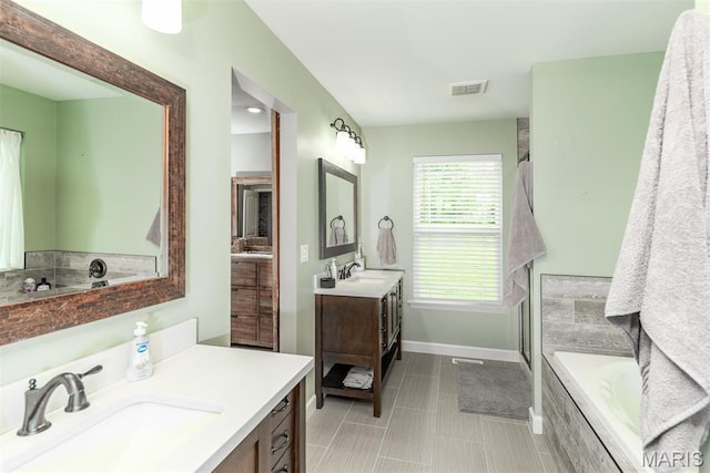 5814 Calvey Creek Rd, Robertsville, MO 63072 - bathroom featuring a garden tub, baseboards, a shower stall, two vanities, and tile patterned flooring