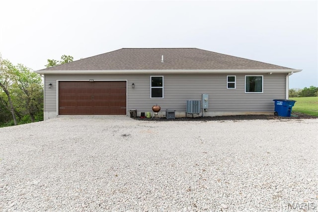 5814 Calvey Creek Rd, Robertsville, MO 63072 - view of side of property featuring driveway, a garage, and roof with shingles