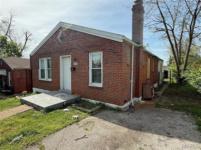820 Elias Ave, Saint Louis, MO 63147 - bungalow-style house with brick siding and a chimney