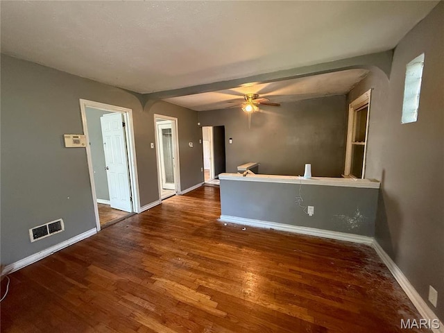 820 Elias Ave, Saint Louis, MO 63147 - empty room featuring wood finished floors, baseboards, arched walkways, and a ceiling fan