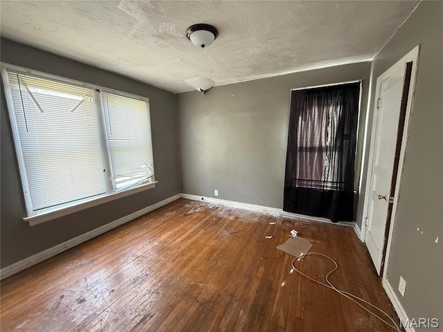820 Elias Ave, Saint Louis, MO 63147 - empty room featuring hardwood / wood-style flooring, baseboards, and a textured ceiling