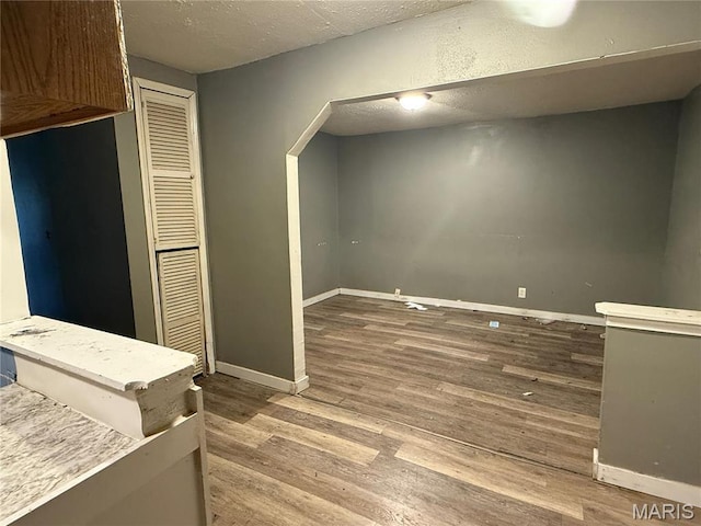 820 Elias Ave, Saint Louis, MO 63147 - basement with wood finished floors, baseboards, and a textured ceiling