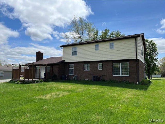1235 S Hackman St, Staunton, IL 62088 - back of house with brick siding, a lawn, and central air condition unit