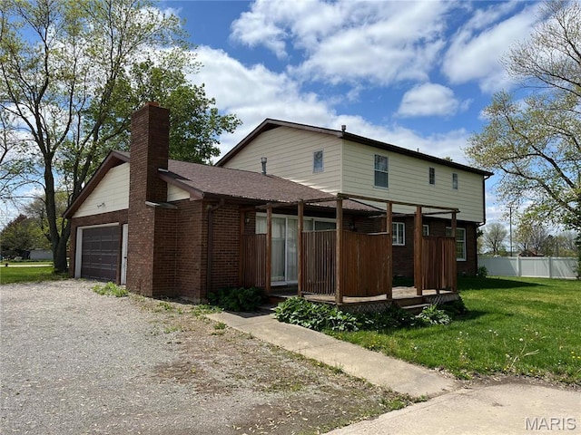 1235 S Hackman St, Staunton, IL 62088 - view of front of home featuring an attached garage, covered porch, dirt driveway, a chimney, and brick siding