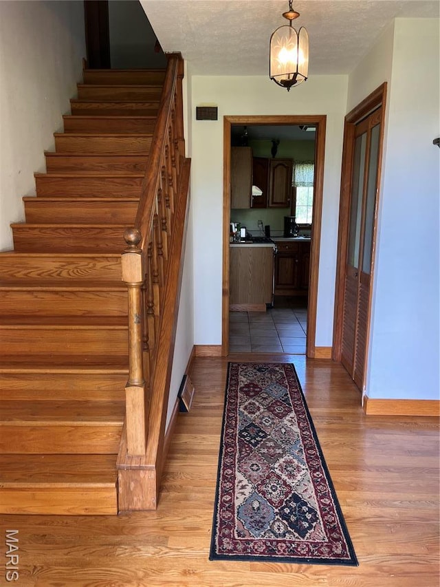 1235 S Hackman St, Staunton, IL 62088 - stairs with baseboards and wood finished floors
