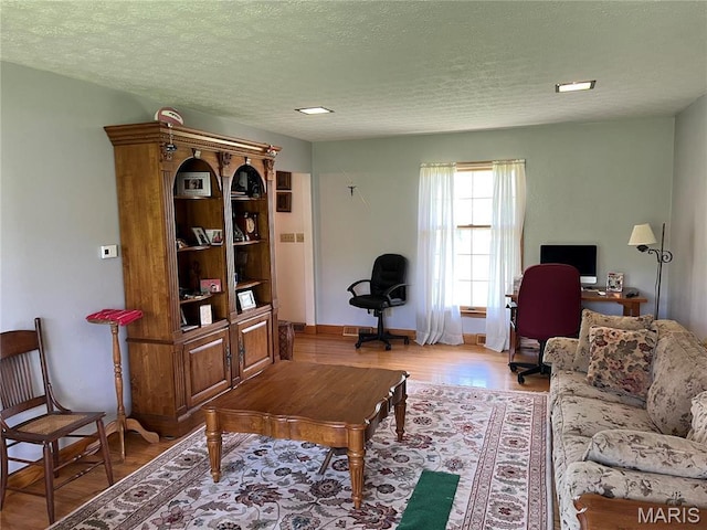 1235 S Hackman St, Staunton, IL 62088 - living area featuring an office area, a textured ceiling, baseboards, and light wood finished floors