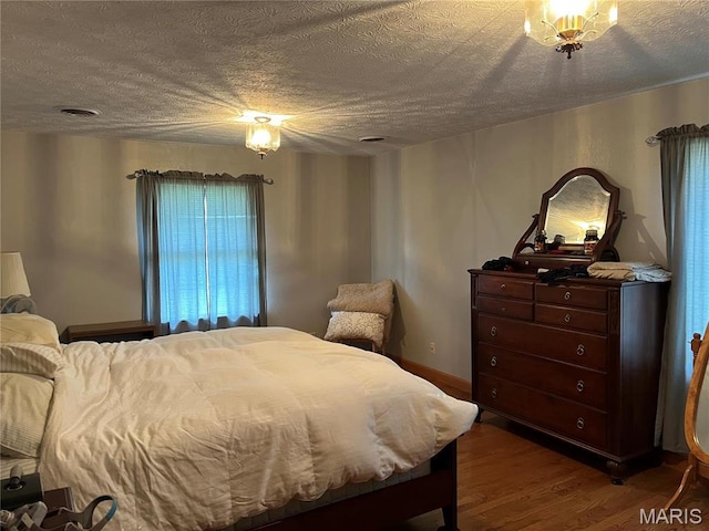 1235 S Hackman St, Staunton, IL 62088 - bedroom with a textured ceiling and wood finished floors