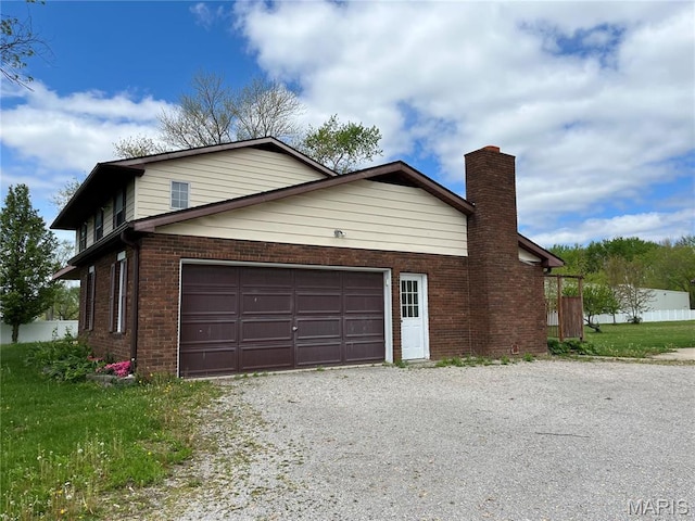 1235 S Hackman St, Staunton, IL 62088 - view of property exterior featuring driveway, brick siding, and a chimney