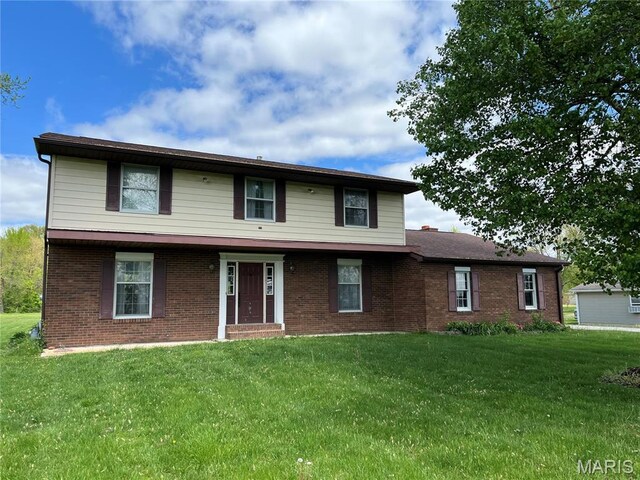 1235 S Hackman St, Staunton, IL 62088 - view of front of house featuring a front yard and brick siding