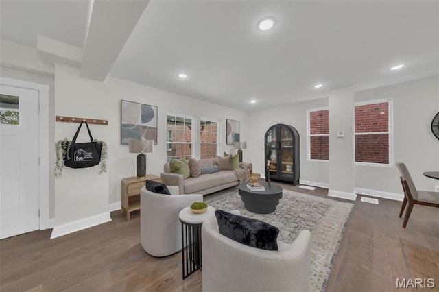 6815 Wise Ave, Saint Louis, MO 63139 - living room with wood finished floors, baseboards, recessed lighting, and plenty of natural light