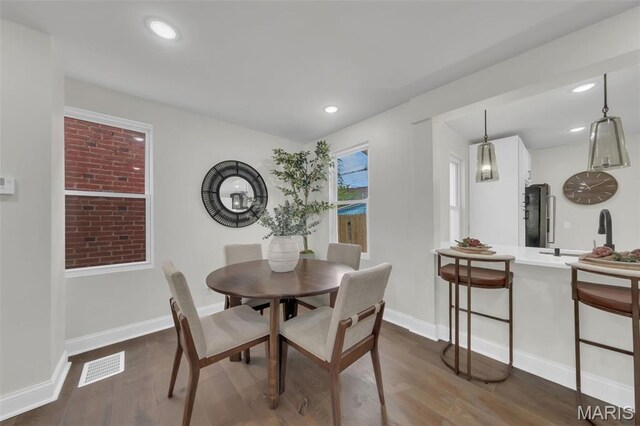 6815 Wise Ave, Saint Louis, MO 63139 - dining room with dark wood-style flooring, recessed lighting, and baseboards