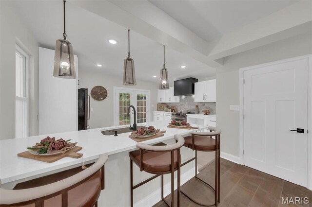 6815 Wise Ave, Saint Louis, MO 63139 - kitchen featuring a sink, stainless steel range with electric stovetop, a breakfast bar, white cabinetry, and light countertops