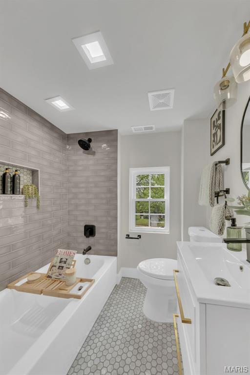6815 Wise Ave, Saint Louis, MO 63139 - full bathroom with toilet, vanity, bathing tub / shower combination, tile patterned floors, and baseboards