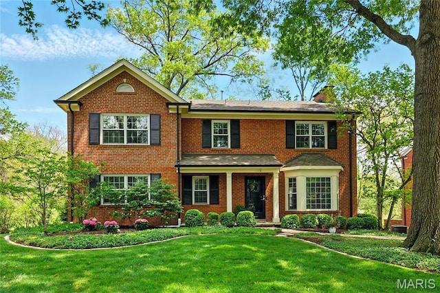 24 Rio Vista Dr, Saint Louis, MO 63124 - colonial home with a front yard and brick siding