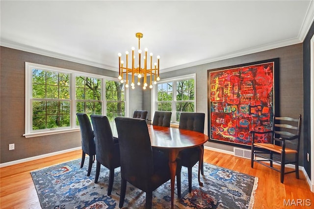 24 Rio Vista Dr, Saint Louis, MO 63124 - dining room with crown molding, a chandelier, wood finished floors, and baseboards