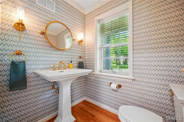 24 Rio Vista Dr, Saint Louis, MO 63124 - bathroom with wood finished floors, toilet, ornamental molding, and baseboards