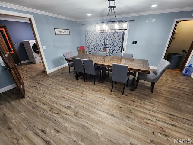 91 N Chantilly Rd, Winfield, MO 63389 - dining room with washer / clothes dryer, wood finished floors, baseboards, a chandelier, and ornamental molding