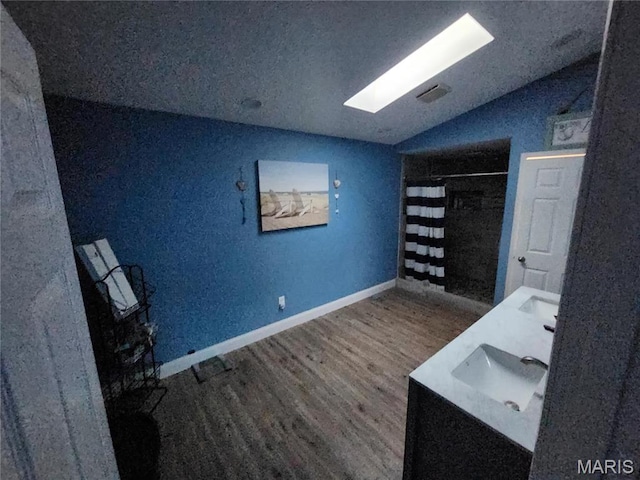 91 N Chantilly Rd, Winfield, MO 63389 - office with vaulted ceiling, wood finished floors, a sink, a skylight, and baseboards