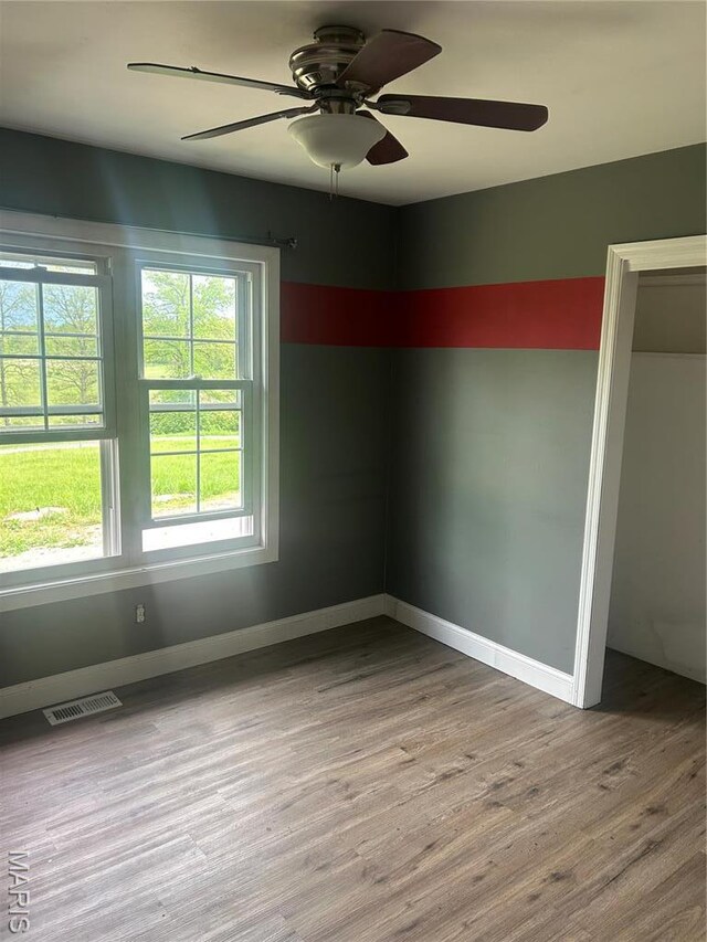 91 N Chantilly Rd, Winfield, MO 63389 - spare room with wood finished floors, ceiling fan, and baseboards