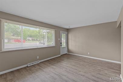 1605 Koch Dr, Florissant, MO 63033 - empty room with baseboards and wood finished floors