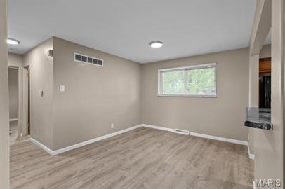 1605 Koch Dr, Florissant, MO 63033 - unfurnished room with baseboards and wood finished floors