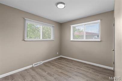 1605 Koch Dr, Florissant, MO 63033 - unfurnished room with baseboards, plenty of natural light, and wood finished floors