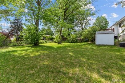1605 Koch Dr, Florissant, MO 63033 - view of green lawn featuring a storage unit and an outdoor structure