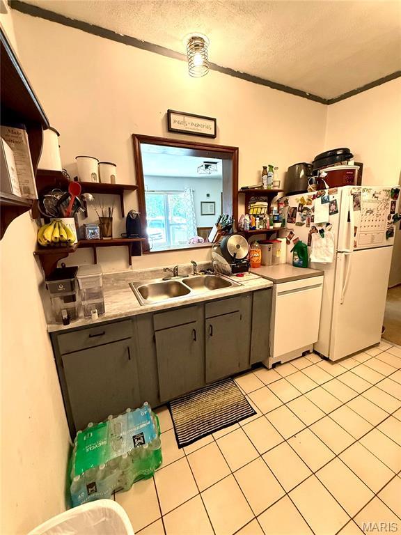 56 Berger Rd, Middletown, MO 63359 - kitchen with open shelves, a sink, light tile patterned floors, a textured ceiling, and light countertops