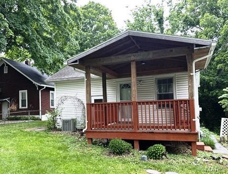 9909 Baltimore St, Belleville, IL 62223 - back of house with a lawn, cooling unit, and covered porch