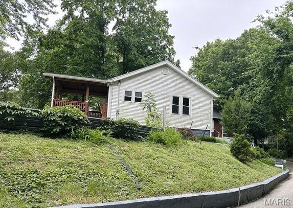 9909 Baltimore St, Belleville, IL 62223 - view of side of home with a yard