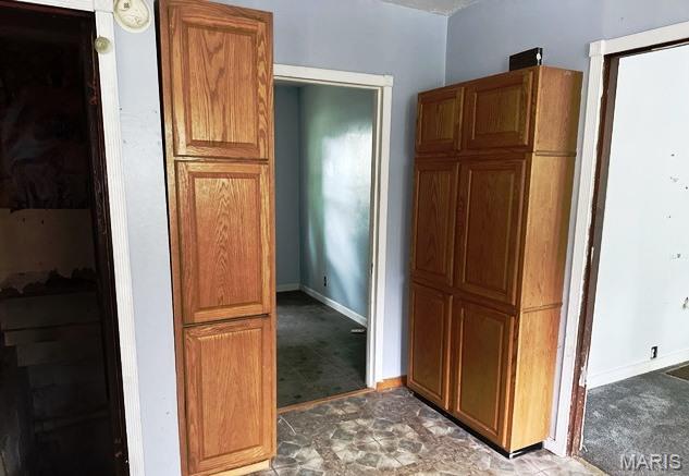 9909 Baltimore St, Belleville, IL 62223 - kitchen featuring baseboards and brown cabinetry