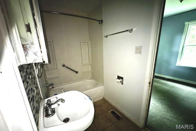 9909 Baltimore St, Belleville, IL 62223 - full bath featuring a sink, baseboards, bathtub / shower combination, and tile patterned floors