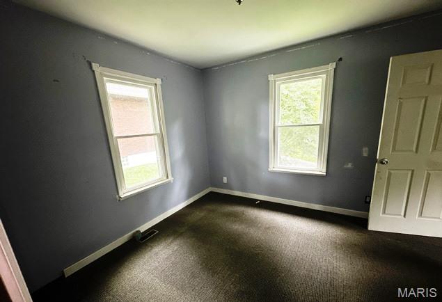 9909 Baltimore St, Belleville, IL 62223 - unfurnished room with dark carpet and baseboards