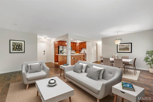 living area featuring dark wood finished floors and baseboards