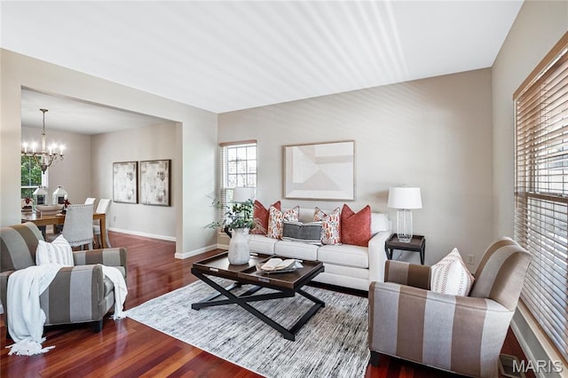 1309 Wellington Valley Ct, Chesterfield, MO 63005 - living room with a chandelier, dark wood-style floors, healthy amount of natural light, and baseboards
