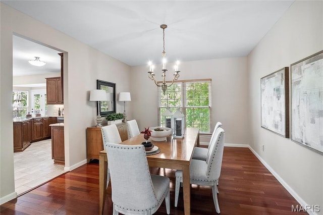 1309 Wellington Valley Ct, Chesterfield, MO 63005 - dining area with wood finished floors, a chandelier, and baseboards