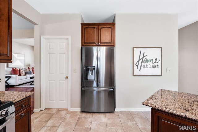 1309 Wellington Valley Ct, Chesterfield, MO 63005 - kitchen featuring stainless steel fridge, light stone counters, and baseboards