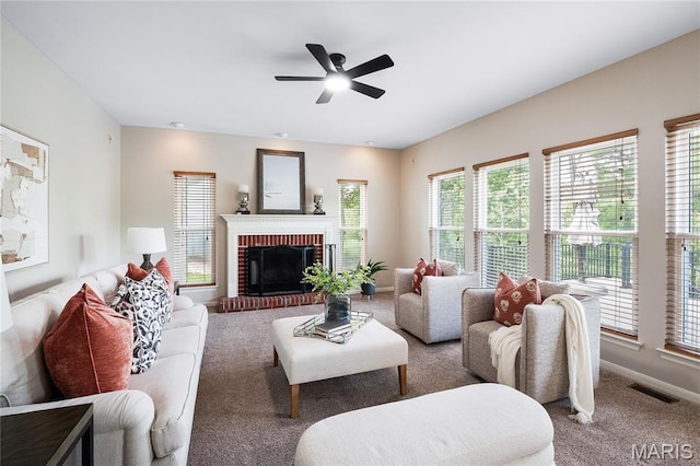 1309 Wellington Valley Ct, Chesterfield, MO 63005 - living area featuring carpet, ceiling fan, a fireplace, and baseboards