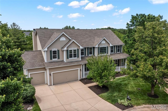 1309 Wellington Valley Ct, Chesterfield, MO 63005 - traditional home featuring driveway, a shingled roof, a garage, and a front lawn