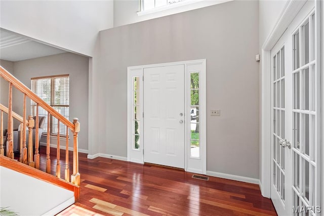 1309 Wellington Valley Ct, Chesterfield, MO 63005 - entrance foyer with wood finished floors, stairs, baseboards, a towering ceiling, and french doors