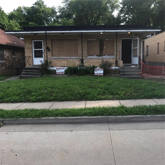 1205 W Mccarty St, Jefferson City, MO 65109 - view of front of house with brick siding, a front yard, entry steps, and a porch
