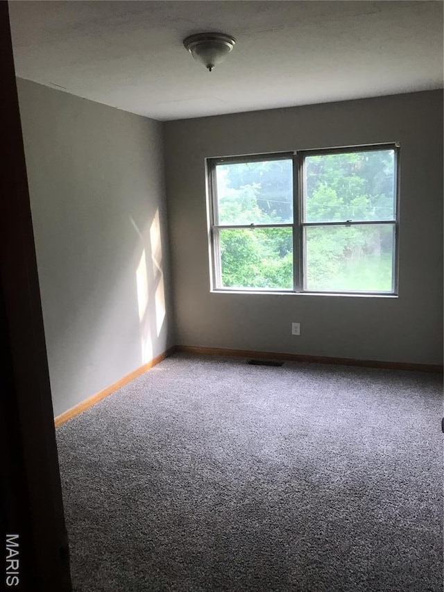 1205 W Mccarty St, Jefferson City, MO 65109 - empty room with carpet flooring and baseboards
