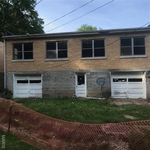 1205 W Mccarty St, Jefferson City, MO 65109 - multi unit property with brick siding, fence, and a garage