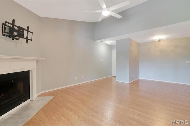 1316 Holgate Dr Unit G5, Ballwin, MO 63021 - unfurnished living room featuring a ceiling fan, high vaulted ceiling, light wood finished floors, a fireplace with flush hearth, and baseboards