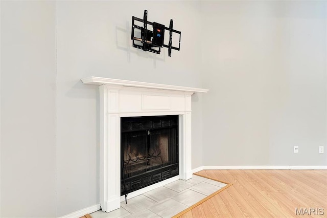 1316 Holgate Dr Unit G5, Ballwin, MO 63021 - detailed view of a fireplace with flush hearth, wood finished floors, and baseboards