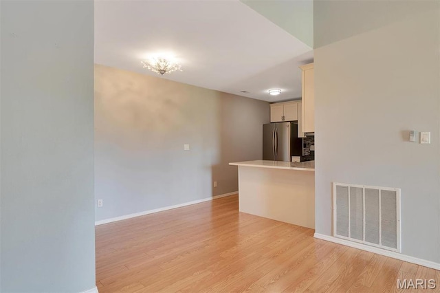 1316 Holgate Dr Unit G5, Ballwin, MO 63021 - unfurnished living room featuring light wood-style floors and baseboards