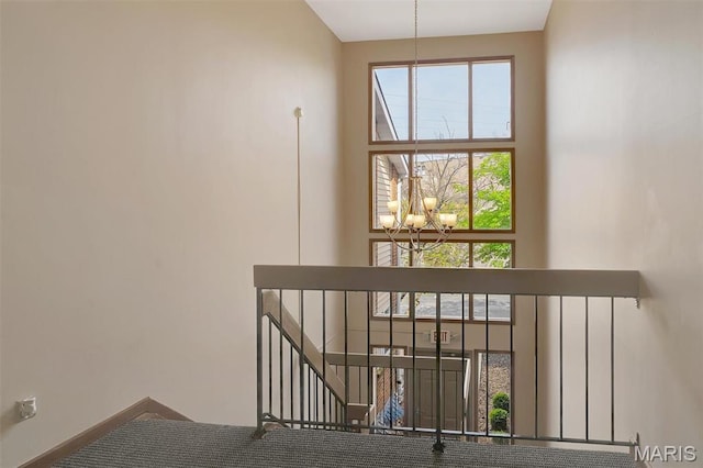 1316 Holgate Dr Unit G5, Ballwin, MO 63021 - staircase featuring a chandelier and a high ceiling