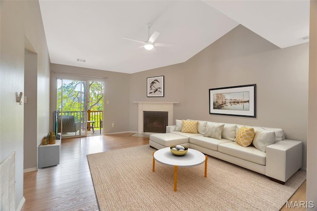 1316 Holgate Dr Unit G5, Ballwin, MO 63021 - living room with a ceiling fan, lofted ceiling, light wood-type flooring, baseboards, and a fireplace with flush hearth